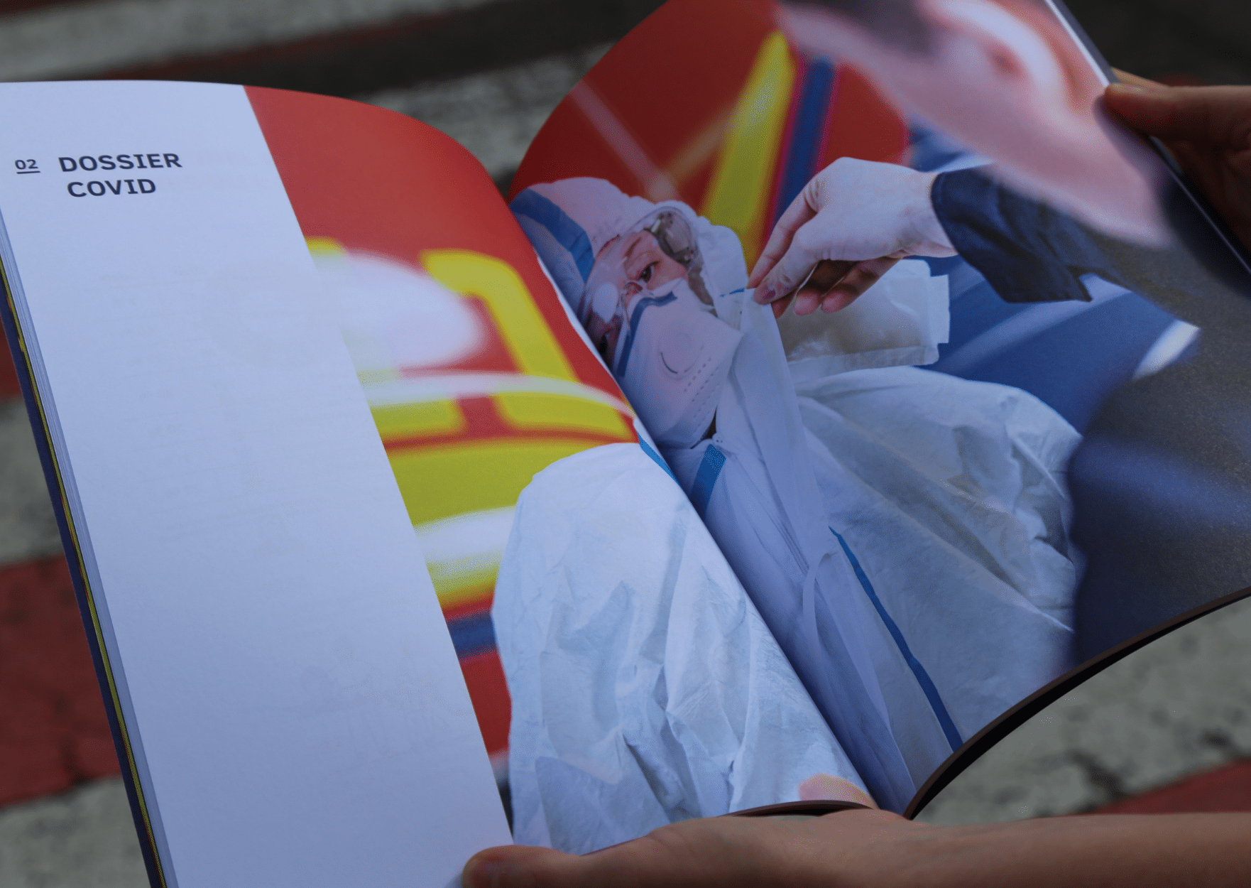 Personne en combinaison de protection COVID en train de réaliser un test de dépistage, visible à travers les pages ouvertes d'un rapport intitulé 'Dossier COVID'.