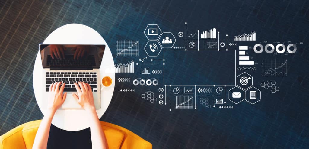 Personne travaillant sur un ordinateur portable avec des graphiques et icônes liés au marketing digital et à la publicité en ligne.